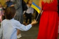 Ukrainian children start a new year of school. Details with a boy holding a Ukrainian flag