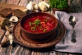 Ukrainian cuisine Borsch is a Ukrainian soup with porcini mushrooms, cabbage, beetroot, onions, carrots and beans in ceramic plate Royalty Free Stock Photo