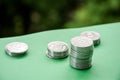 Ukrainian coins on a green background. Stacks of coins. 5 cents on the table.