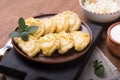 Ukrainian dumplings, pierogi or pyrohy, varenyky, vareniki, served with cottage cheese on board. National Russian cuisine, natural