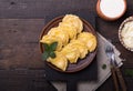 Ukrainian dumplings, pierogi or pyrohy, varenyky, vareniki, served with cottage cheese on board. National Russian cuisine, natural