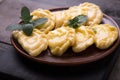 Ukrainian dumplings, pierogi or pyrohy, varenyky, vareniki, served with cottage cheese on board. National Russian cuisine, natural