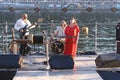 Ukrainian ethno band playing music on the beach, Dnipro river on a background