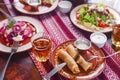 Ukrainian family in traditional closes has a dinner. Ukrainian culture. Family eating and clang glasses together.