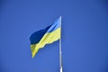 Ukrainian flag against the blue cloudless sky. The official flag of the Ukrainian state includes yellow and blue color Royalty Free Stock Photo