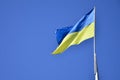 Ukrainian flag against the blue cloudless sky. The official flag of the Ukrainian state includes yellow and blue color Royalty Free Stock Photo