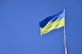 Ukrainian flag against the blue cloudless sky. The official flag of the Ukrainian state includes yellow and blue color Royalty Free Stock Photo