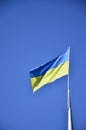 Ukrainian flag against the blue cloudless sky. The official flag of the Ukrainian state includes yellow and blue color Royalty Free Stock Photo