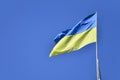 Ukrainian flag against the blue cloudless sky. The official flag of the Ukrainian state includes yellow and blue color Royalty Free Stock Photo