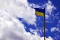 Ukrainian flag against the blue sky with clouds. The official flag of the Ukrainian state includes yellow and blue color Royalty Free Stock Photo