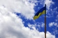 Ukrainian flag against the blue sky with clouds. The official flag of the Ukrainian state includes yellow and blue color Royalty Free Stock Photo