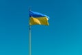 Ukrainian flag against the blue sky. Waving yellow-blue Ukrainian on the background of sky Royalty Free Stock Photo