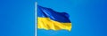 Ukrainian flag against a blue sky. Yellow and blue colors. National symbol of Ukraine. Russian war in Ukraine. Stop war