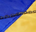 Ukrainian flag. The chain on the flag is Russia\'s attempt to enslave Ukraine