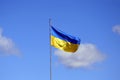 Ukrainian flag on flagpole against the blue cloudless sky. The official flag of the Ukrainian state includes yellow and blue color Royalty Free Stock Photo