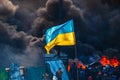 The Ukrainian flag flies against the backdrop of burning Kyiv