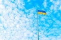 Ukrainian Flag Flying High Amidst Towering Cumulus Clouds