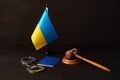 Ukrainian flag and handcuffs on black background, concept of crime and justice in the country Royalty Free Stock Photo