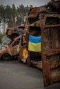 Ukrainian flag hangs on burned cars