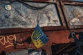 a Ukrainian flag stands on the broken russian equipment Royalty Free Stock Photo