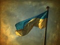 Ukrainian flag waving in the wind against a blue sky. Photo like a ancient canvas Royalty Free Stock Photo