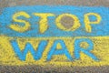 Ukrainian flag with words Stop War drawn with colorful chalks on asphalt outdoors, closeup Royalty Free Stock Photo