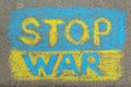 Ukrainian flag with words Stop War drawn with colorful chalks on asphalt outdoors, top view Royalty Free Stock Photo