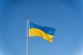 Ukrainian flag of yellow-blue colors on the background of clear blue sky Royalty Free Stock Photo