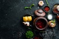 Ukrainian food. Borsch with lard, garlic and donuts on a black stone background. Top view. Rustic style