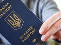 Ukrainian foreign biometric passport in hand, close-up