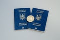 Ukrainian foreign passports and bitcoin coin. Ukraine and cryptocurrency concept. on white background