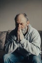 Ukrainian frightened gray haired middle aged man prays