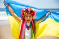 Ukrainian girl carries blue and yellow flag of Ukraine fluttering on the blue sky background Royalty Free Stock Photo