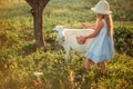 Ukrainian girl on a farm feeds a goat. Cute little girl with long blonde hair at sunny sunset spends time with a pet. Cute baby 6 Royalty Free Stock Photo