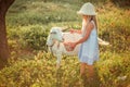 Ukrainian girl on a farm feeds a goat. Cute little girl with long blonde hair at sunny sunset spends time with a pet. Cute baby 6 Royalty Free Stock Photo