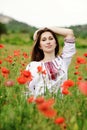 Ukrainian girl in field of poppies Royalty Free Stock Photo