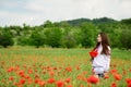 Ukrainian girl in poppy field Royalty Free Stock Photo