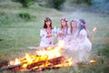 Ukrainian girl in shirts sitting around the campfire Royalty Free Stock Photo