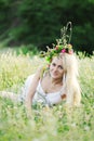 Ukrainian girl in a white sundress and a wreath of flowers on he Royalty Free Stock Photo