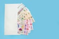 Ukrainian hryvnia in a white envelope isolated on a blue background. Copy of space. 200, 500, 1000 hryvnias. Financial concept. Royalty Free Stock Photo