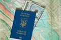 Ukrainian passport and American dollars are on the map Royalty Free Stock Photo