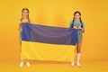 Ukrainian kids. Girls with blue and yellow flag. Patriotic education. Happy independence day. Children hold ukrainian