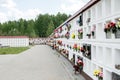 Ukrainian military cemetery with a tombstone and artificial flowers on a sunny summer day