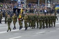 Ukrainian military men, officers flying flag, marching on a square during military parade dedicated to Day of Independence of