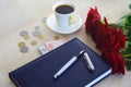 Ukrainian money, a diary with a pen, coffee and roses Royalty Free Stock Photo