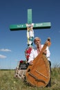 Ukrainian musician with bandura under cross Royalty Free Stock Photo