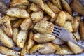 Ukrainian national dish is baked potatoes. Ceramic bowl with potato slices background, top view