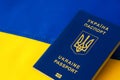 Ukrainian passport against the background of the Ukrainian flag