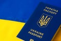 Ukrainian passport against the background of the Ukrainian flag