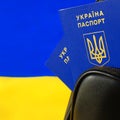 Ukrainian passport in a backpack against the background of the Ukrainian flag. Immigration of people in connection with the war